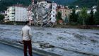 A man looks on as flood waters sweep by in Bozkurt town of Kastamonu province of Turkey on Thursday. Photograph: AP