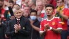 Manchester United manager Ole Gunnar Solskjær and Jadon Sancho applaud off Daniel James as Sancho waits to come on and make his league debut at Old Trafford. Photograph: Adrian Dennis/AFP via Getty Images