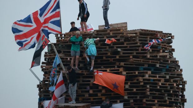 British flags and unionist banners are placed upon a large bonfire being built to mark the Catholic Feast of the Assumption in the Galliagh area of Derry, Northern Ireland, before being lit on Sunday. Photograph: Liam McBurney/PA Wire