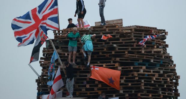 British flags and unionist banners are placed upon a large bonfire being built to mark the Catholic Feast of the Assumption in the Galliagh area of Derry, Northern Ireland, before being lit on Sunday. Photograph: Liam McBurney/PA Wire