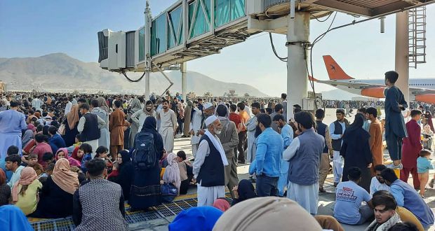 Afghans crowd at the tarmac of the Kabul airport after the city fell to the Taliban. Photograph: AFP/Getty Images