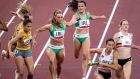 Phil Healy passes the baton to Ireland team-mate Sophie Becker during the final of the mixed 4x400m relay at the Tokyo Olympics. Photograph:  Morgan Treacy/Inpho