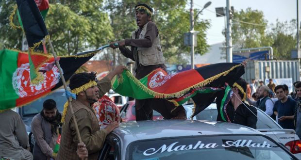 People carry Afghanistan’s national flag on the 102nd Independence Day of the country in the Wazi Akbar khan area of Kabul on Thursday. Photograph:  Hoshang Hashimi/AFP via Getty Images