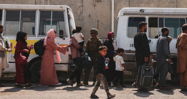 Evacuees load on to buses to be processed during an evacuation at Hamid Karzai International Airport, Kabul, on Sunday. Photograph: US Marine Corps/AFP via Getty Images