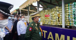 Myanmar’s minister of home affairs, lieutenant general Soe Htut, examines  seized drugs  in Yangon in June. Photograph: AFP via Getty Images