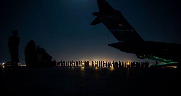 People queue to board a US miltary aircraft at Kabul airport over the weekend. Photograph: Taylor Crul/ AFP via Getty