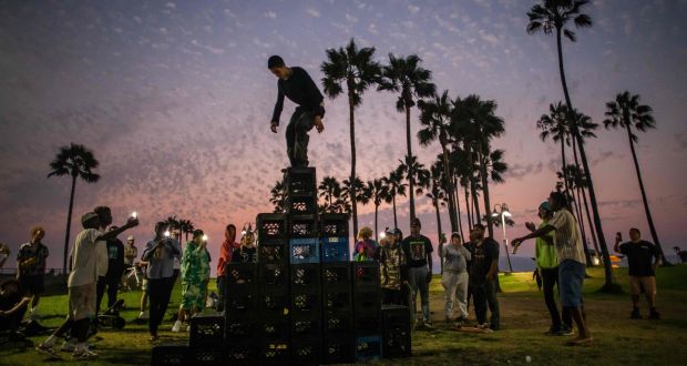 A man walks up a pyramid of milk crates as he takes part of the milk crate challenge, in Venice, California on August 24th, 2021. Photograph: Apu GOMES / AFP