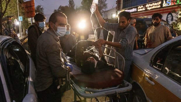 A person wounded in a bomb blast outside Kabul airport in Afghanista arrives at a hospital in Kabul. Photograph: Victor J Blue/The New York Times