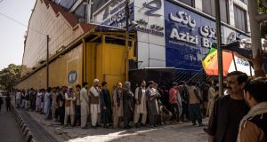 People line up outside a bank in Kabul on Sunday. Photograph: Jim Huylebroek/New York Times