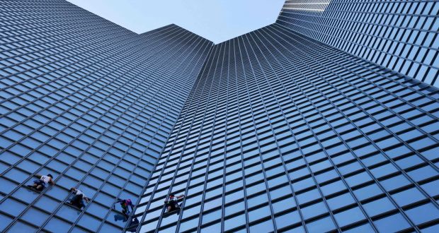 French urban climber Alain Robert (second from right) and three of his similarly adventurous friends climb the Total tower in La Défense, Paris, on Tuesday. Photograph: Thomas Samson/AFP
