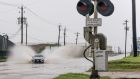 A car speeds through a flooded street ahead of the Hurricane Nicholas in Galveston, Texas. Photograph: Brandon Bell/Getty Images
