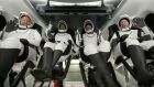 Passengers aboard a SpaceX capsule react as the capsule parachutes into the Atlantic Ocean off the Florida coast. Photograph: SpaceX/AP