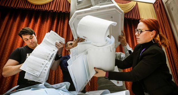 Members of a local electoral commission  at a Moscow polling station after the last day of the three-day parliamentary election, on Sunday. Photograph: Alexander Nemenov/AFP via Getty Images