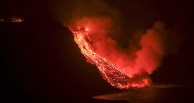 Lava flow from the Cumbre Vieja volcanic eruption in La Palma reaching the sea in an area of cliffs next to Tazacortes coast, Canary Islands, on Tuesday night. Photograph: EPA