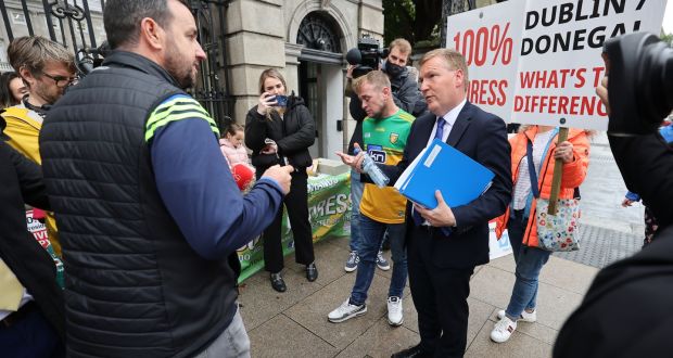 Minister for Public Expenditure and Reform Michael McGrath with mica/pyrite protesters outside the Dáil. Photograph: Nick Bradshaw 