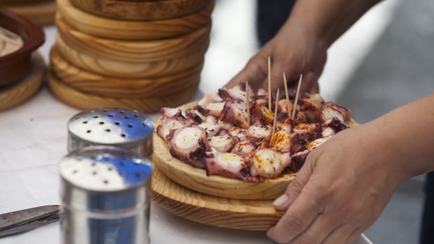 Preparing and serving the famous dish Pulpo in Galicia