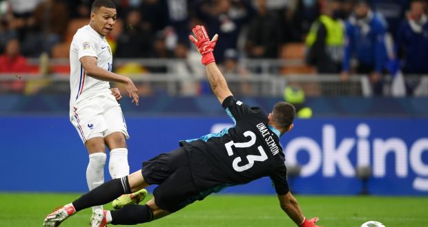  French striker Kylian Mbappé scores his side’s  second goal past Spanish goalkeeper Unai Simon  during the Uefa Nations League  Final at San Siro Stadium in Milan. Photograph: Mike Hewitt/Getty Images