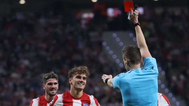 German referee Daniel Siebert shows the red card to Atlético Madrid’s Antoine Griezmann. Photograph: Juanjo Martin/EPA