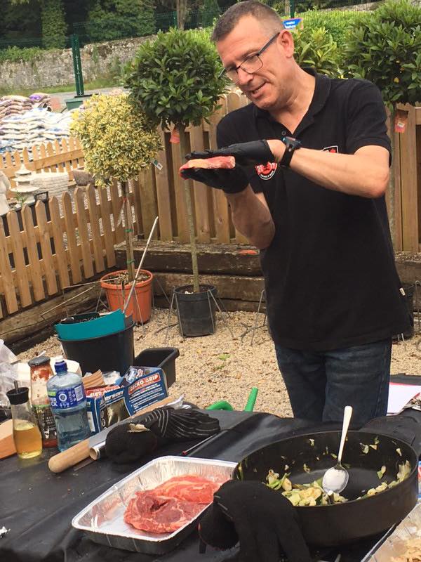 Mark Doe in the back garden preparing meat for the barbecue