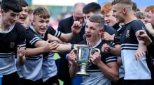 Newbridge’s Patrick Taylor celebrates with his teammates after their  Leinster Schools Junior Cup. Photograph: Ben Brady/Inpho
