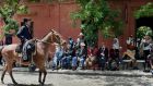 Tourists watch gauchos parade during a festival in San Antonio de Areco, Argentina. photograph: daniel garcia, afp/getty