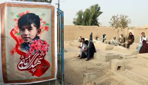 A photograph of Ali, a 13-year-old victim of a bomb attack  on a Shia mosque in Kandahar, Afghanistan,  on October 15th, in which 32 people died, is displayed during his funeral. The Islamic State terror group claimed responsiblity for the attack. Photograph: EPA