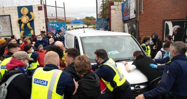 Gardaí attempt to hold back protestors as a work van attempts to leave a site where people were evicted from a site on Prussia Street in Dublin city centre. Photograph: Damien Eagers/The Irish Times