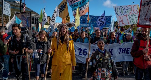 Demonstrators calling for action on the climate crisis march through Glasgow, Scotland, on the eve of the Cop26 Summit. Photograph: Andrew Testa/The New York Times