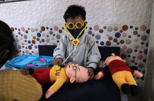 PLAYING DOCTOR: Masked primary school students play in class on their first day of school following the easing of Covid-19 restrictions at the Rajkiya Sarvodaya Bal Vidyalaya school, in New Delhi, India. Photograph: Rajat Gupta/EPA