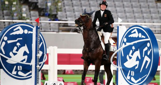 Germany’s Annika Schleu shows her distress after Saint Boy hits  an obstacle during the showjumping section of the modern pentathlon at the Tokyo Olympics. Photograph: Tatyana Zenkovich/EPA