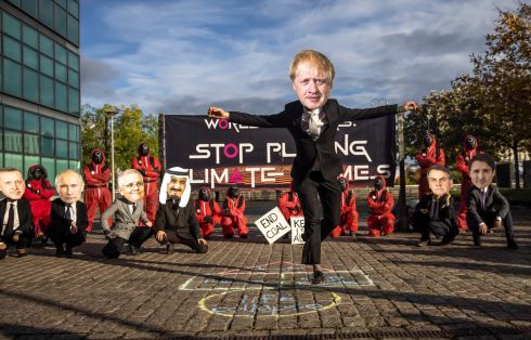 MAKE OR BREAK: A climate-change activist from the Glasgow Actions Team in a Boris Johnson mask takes part in a Squid Game-themed demonstration while other "world leaders" look on, as the Cop26 climate talks take place nearby, in Glasgow, Scotland. Photograph: Jonne Roriz/Bloomberg

