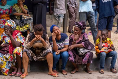 BUILDING COLLAPSE: People wait for news about loved ones trapped under the rubble of a collapsed 21-storey building in Ikoyi, Lagos, Nigeria, which was still under construction. Scores of people are still missing. Rescue crews pulled two more survivors out of the ruins on Tuesday and were communicating with others buried inside, a day after the disaster. Photograph: Benson Ibeabuchi/AFP/Getty

