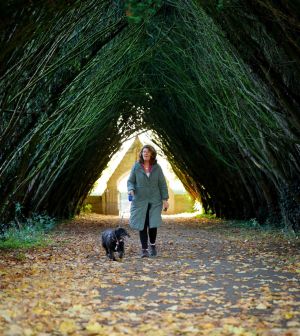 Sandra Doherty walking her dog Lizzy in the grounds of the National University of Ireland Maynooth during autumnal leaf fall. Photograph: Alan Betson