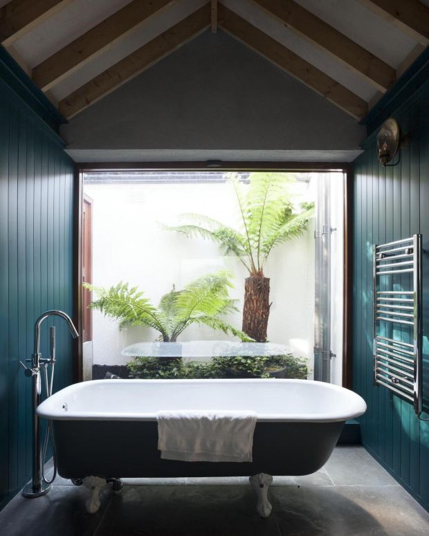 Bathroom looking out to small courtyard. Photograph: Alice Clancy