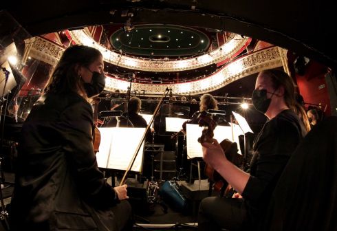 RETURN TO GAIETY: Alison Comerford (left), and Aoife Magee warming up in the orchestra pit ahead of the opening performance of Irish National Opera's Fidelio, by Beethoven, at Dublin's Gaiety Theatre. With an orchestra of 44 and a chorus of 28, this is the first return to full opera production for the company since March 2020. Photograph: Mark Stedman

