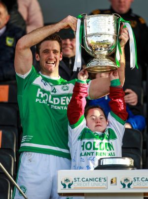 HIGH - AND MIGHTY: Ballyhale Shamrocks' Colin Fennelly raises the Tom Walsh Cup with help from Donna Malone after his side's win over O'Loughlin Gaels in the Kilkenny Senior Hurling Championship Final, UPMC Nowlan Park, Kilkenny. Photograph: Ken Sutton/Inpho

