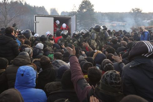 MIGRANT CRISIS: Migrants gather to receive humanitarian aid in a camp on the Belarusian-Polish border in the Grodno region. Hundreds of desperate migrants are trapped in freezing temperatures on the border and the presence of troops from both sides has raised fears of a confrontation. Photograph: Ramil Nasibulin/Belta/AFP via Getty