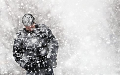 MOSCOW SNOW:  A man walks on a street during a snowfall in the town of Podolsk, outside Moscow, in Russia. The temperature exceeded two degrees in the Moscow region.  Photograph: Maxim Shipenkov/EPA
