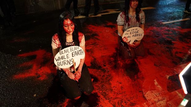 Climate activists protest in fake blood as the Cop26 summit nears to a close. Photograph: Andrew Milligan/PA