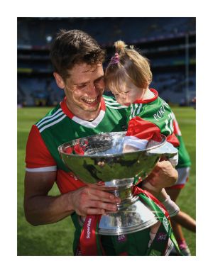 25 July 2021; Reflected glory. The Connacht final is relocated to Croke Park to accommodate a crowd of 18,000 and the switch suits Mayo just fine, as can be gleaned from a beaming Lee Keegan with his 14-month-old daughter Líle and the Nestor Cup. This is not the first time the Connacht decider moved west to east as the replayed 1922 final between Galway and Sligo took place on Jones' Road in September 1923. Photo by Ray McManus/Sportsfile 