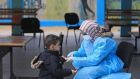 A health worker checks the temperature of a child at a UN school at al-Shati refugee camp in Gaza city. File photograph: Mahmoud Hams/AFP via Getty Images