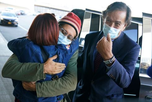 RELEASED: Danny Fenster (centre) hugs his mother Rose Fenster as former US diplomat Bill Richardson (right) looks on at John F Kennedy Airport in New York on Tuesday. Fenster was sentenced last week to 11 years of hard labour in Myanmar. He was handed over Monday to Richardson, who helped negotiate the release. Photograph: Seth Wenig/AP