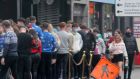  Some passersby and a large queue are seen  outside a pub in  Limerick on Wednesday afternoon. Photograph: Press 22