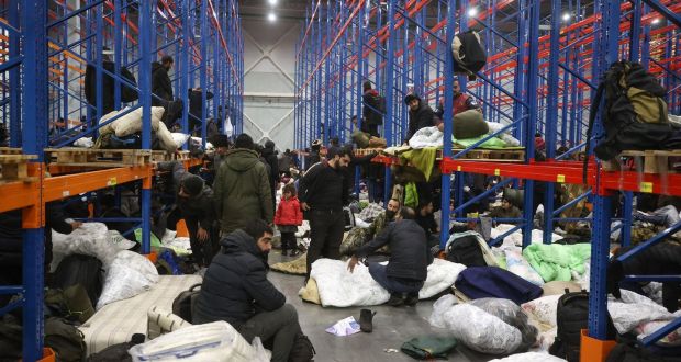 Hundreds of migrants were moved from the border to a warehouse in Belarus on Thursday night. Photograph: Leonid Shcheglov/Belta/AFP via Getty