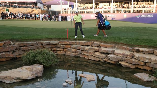 McIlroy looks for his ball in the creek on the 18th. Photo: Warren Little/Getty Images