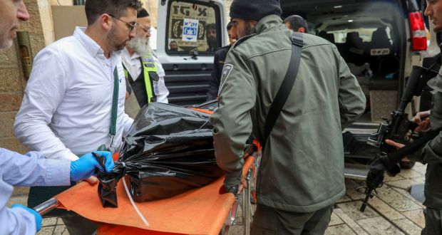 Israeli security personnel carry the body of a Palestinian man who was fatally shot by Israeli police after he killed one Israeli and wounded four others. Photograph: Mahmoud Illean/AP Photo