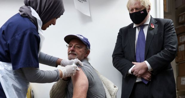 Britain’s prime minister Boris Johnson looks on as a health worker administers a Covid-19 vaccination at a pharmacy in Sidcup, south east London on November 12th. Photograph: Henry Nicholls/AFP via Getty Images