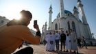Muslims pose for a photograph outside the Kul Sharif mosque  in Kazan during a celebration of Eid al-Fitr festival on May 13th last. Photograph: Yegor Aleyev/Tass via Getty Images