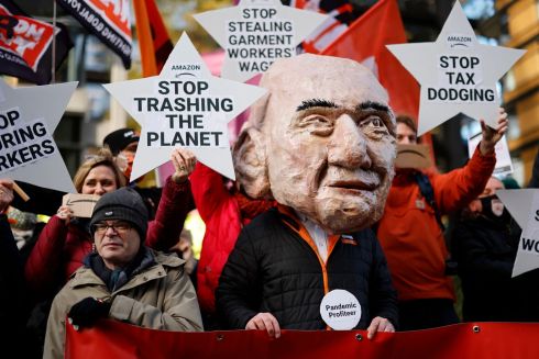 AMAZON PROTEST: An Extinction Rebellion activist, wearing a mask depicting Jeff Bezos, takes part in a protest outside of Amazon's HQ in central London. Photograph: Tolga Akmen/AFP via Getty Images

