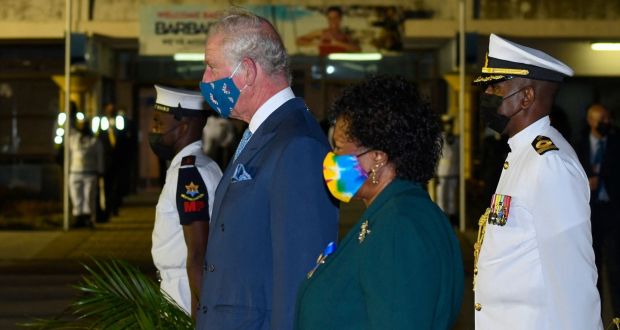 Prince Charles and Barbados president-elect Dame Sandra Mason  stand at attention as the national anthem plays at Grantley Adams International Airport in Christ Church, Barbados on Sunday. Photograph: Randy Brooks/AFP via Getty 